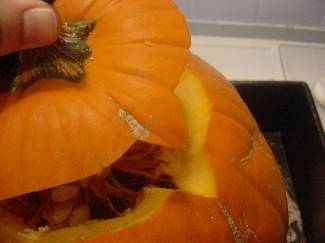 Cutting the lid on a pumpkin